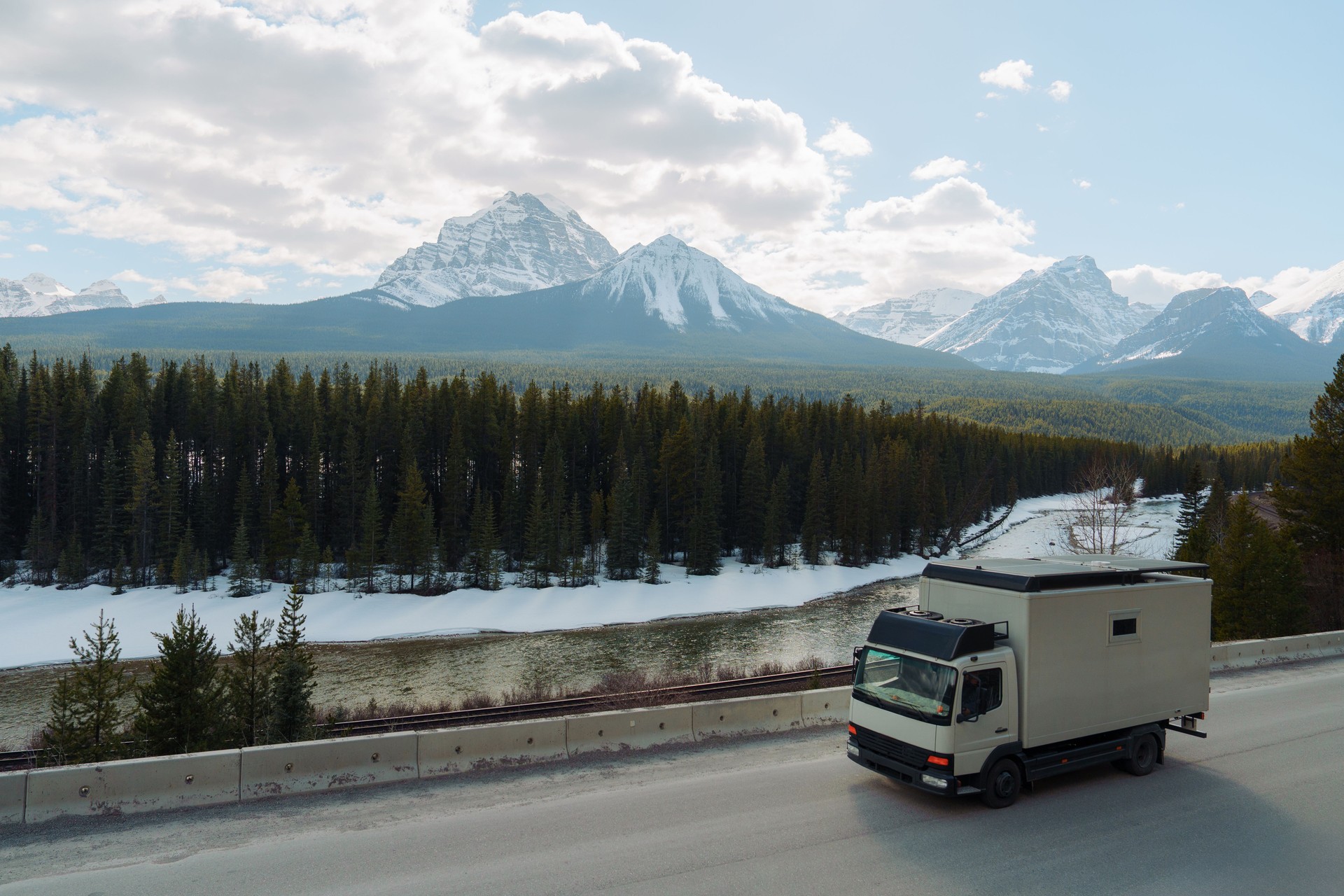 Truck on highway through  Canadian Rockies in spring